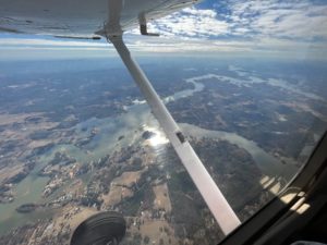 Wing view of ground from a Cessna 172 plane