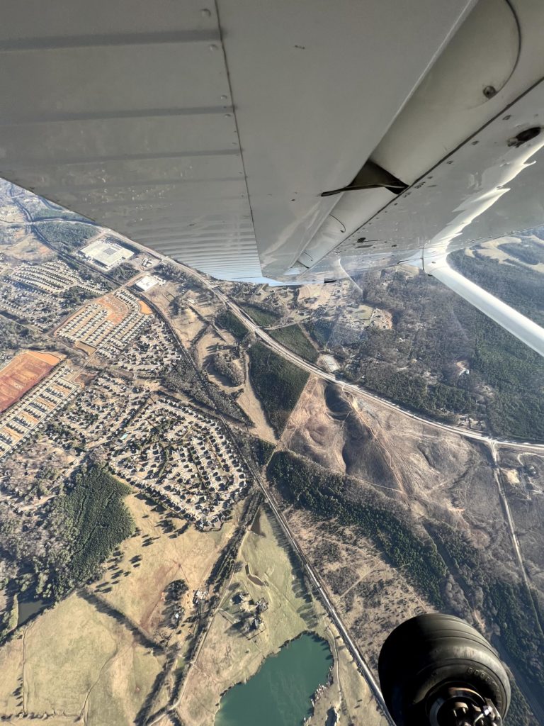 wing view of the ground from an airplane